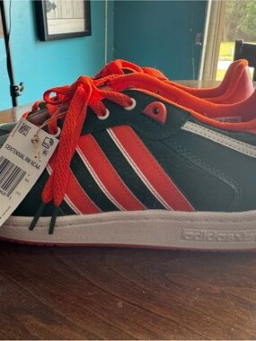 Adidas men’s size 8.5 green and orange sneakers.